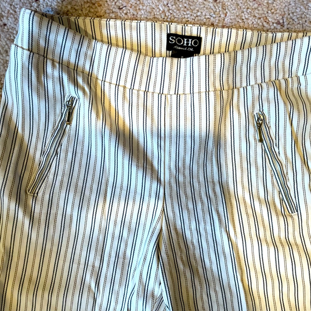 white stretch denim skinny pants. Pin stripes Small, zip up pockets